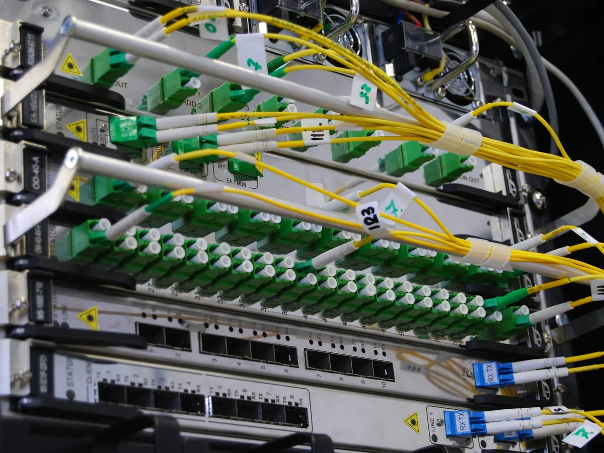 Network switch in a rack with fibre optic cables, tidy and labelled